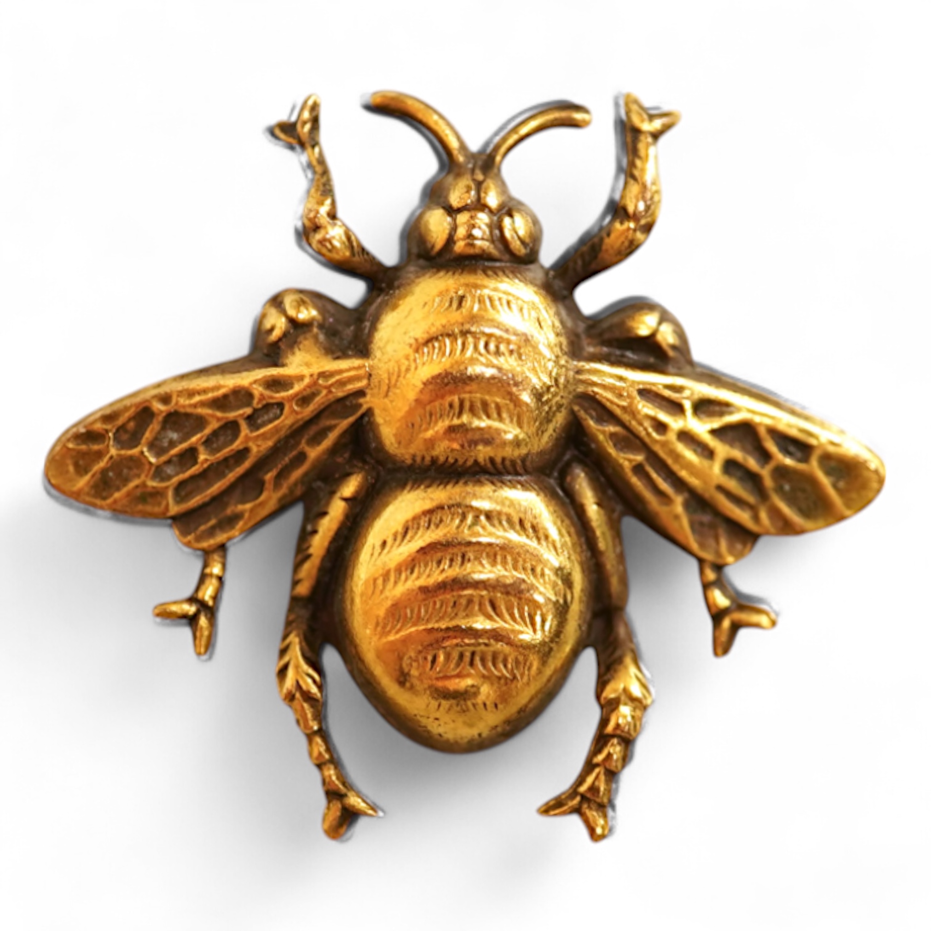A mid 20th century North American gilt metal bee brooch by Joseff, wing span 30mm, together with a hard back copy of 'Jewelry of the Stars, Creations from Joseff of Hollywood' by Joanne Dubbs Ball.